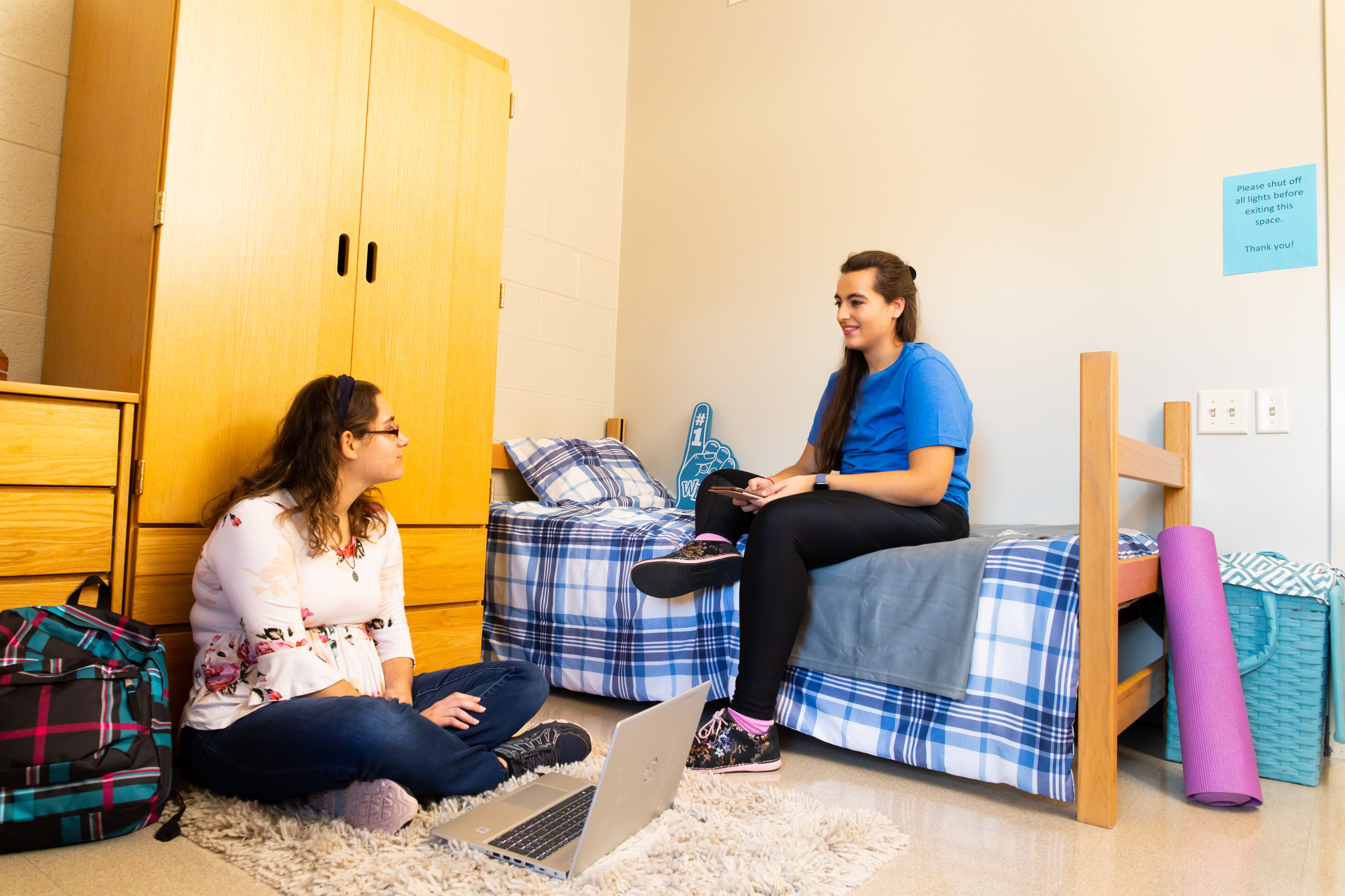 Two students talking in residence hall dorm room