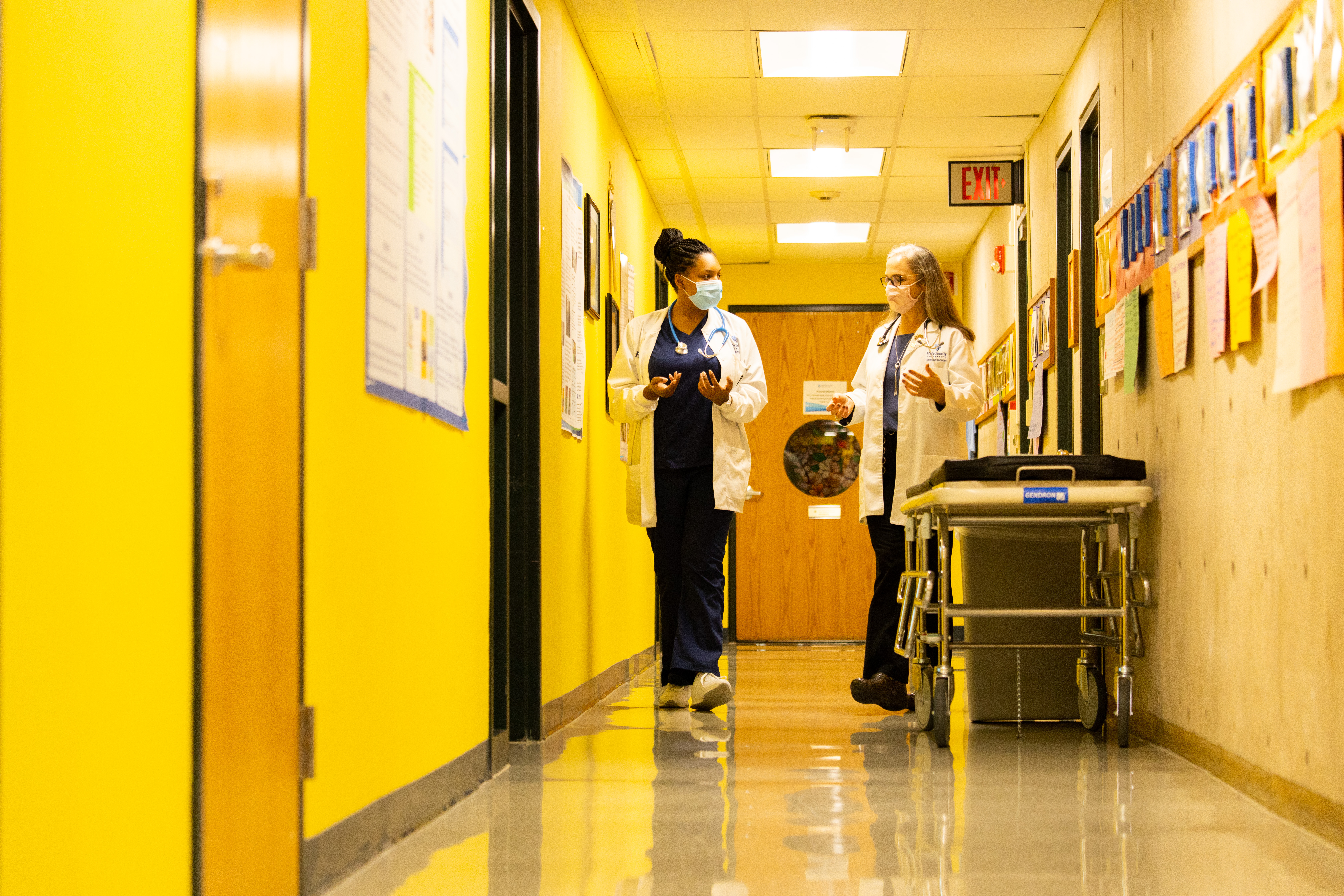 Dr. and student walk through Nursing Education Center