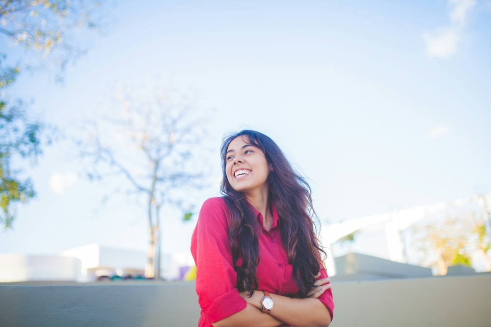 Female college student smiling outdoors on campus