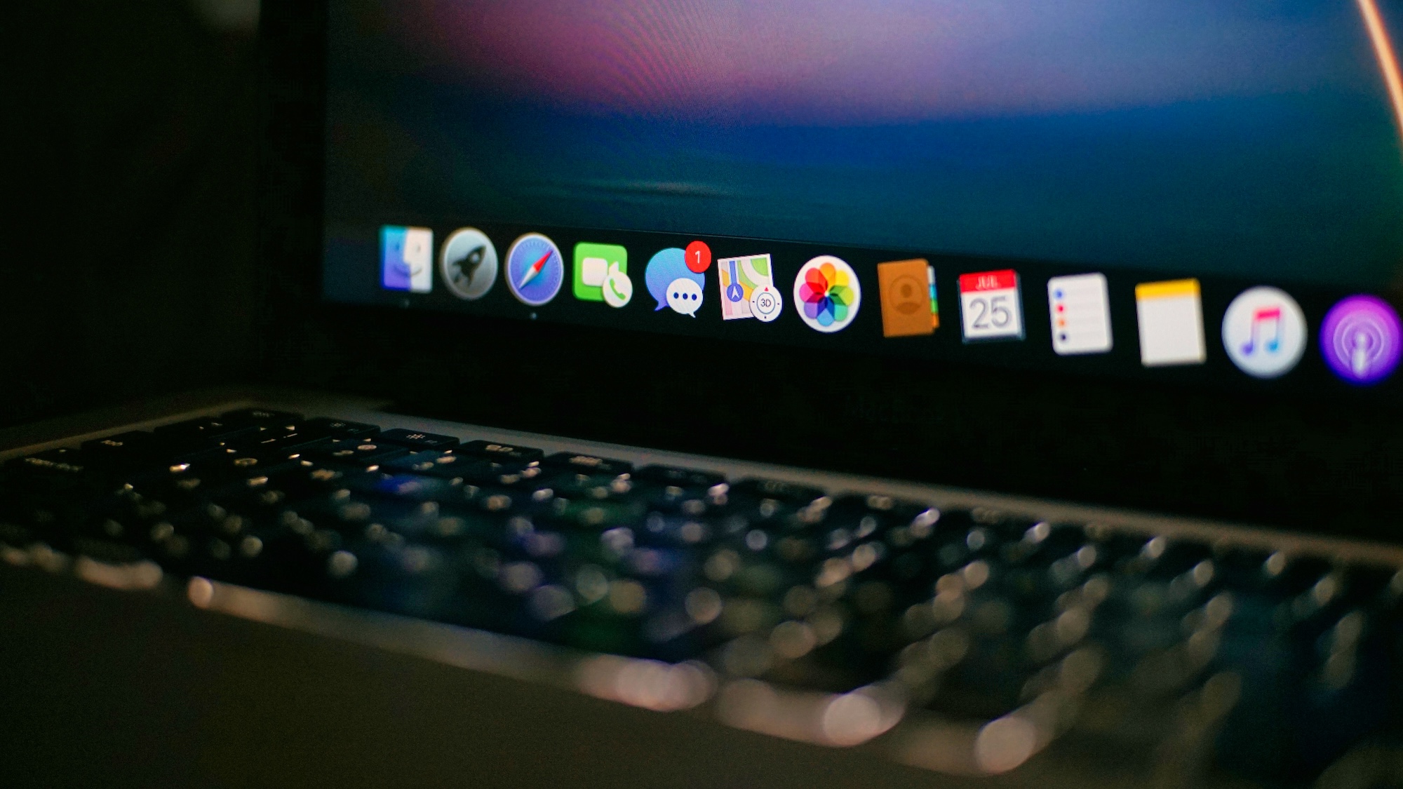 A laptop screen with a variety of different applications' icons showing