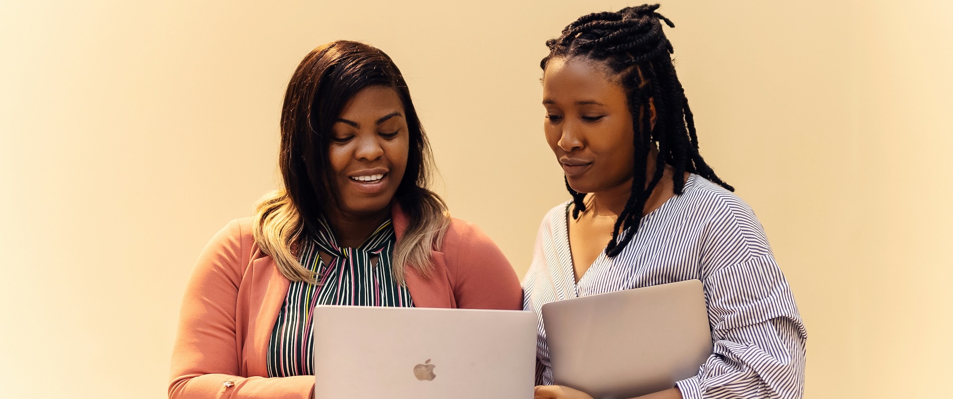 Two workers discussing work over a laptop