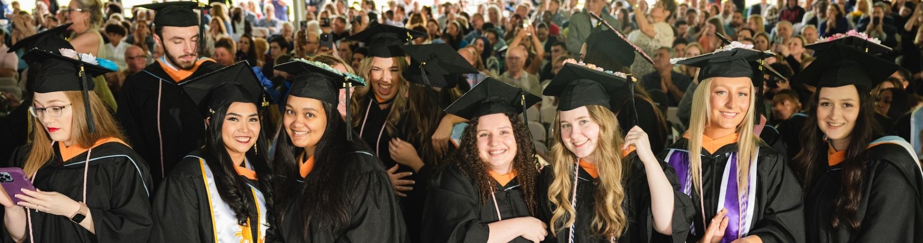 Holy Family University students celebrating graduation at commencement