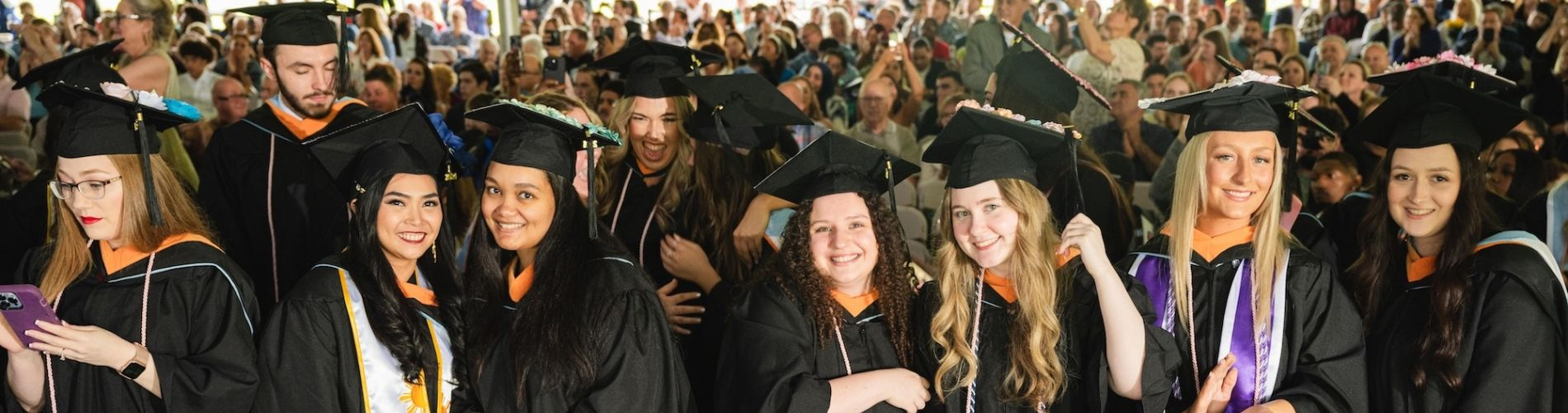 Holy Family University students celebrating graduation at commencement