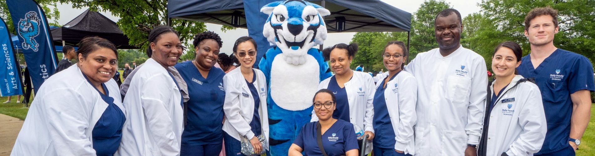 A group of Holy Family University nursing students pose for a photo with the university mascot