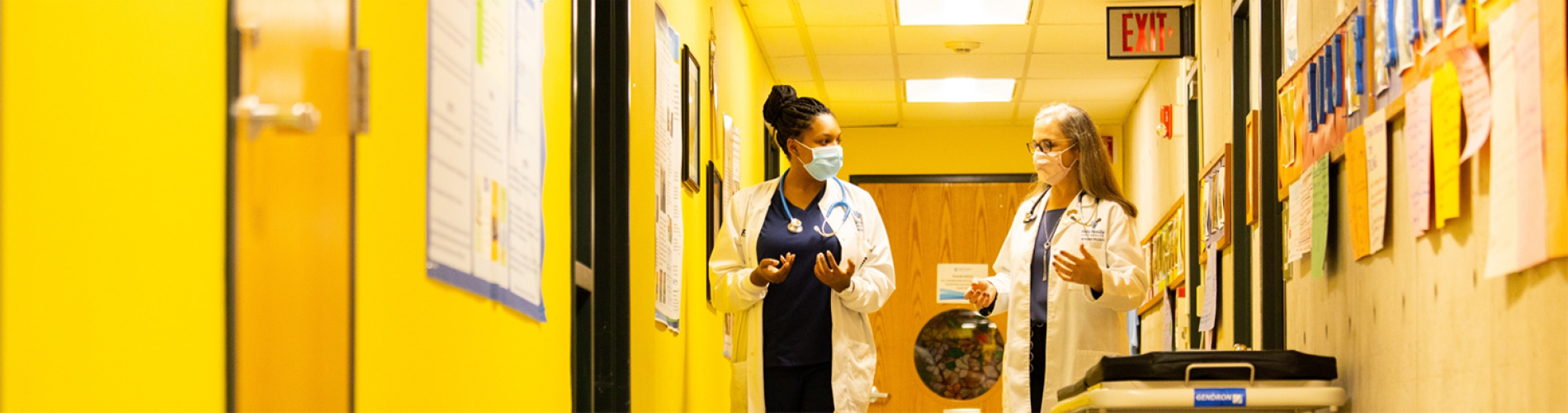 Dr. and student walk through Nursing Education Center