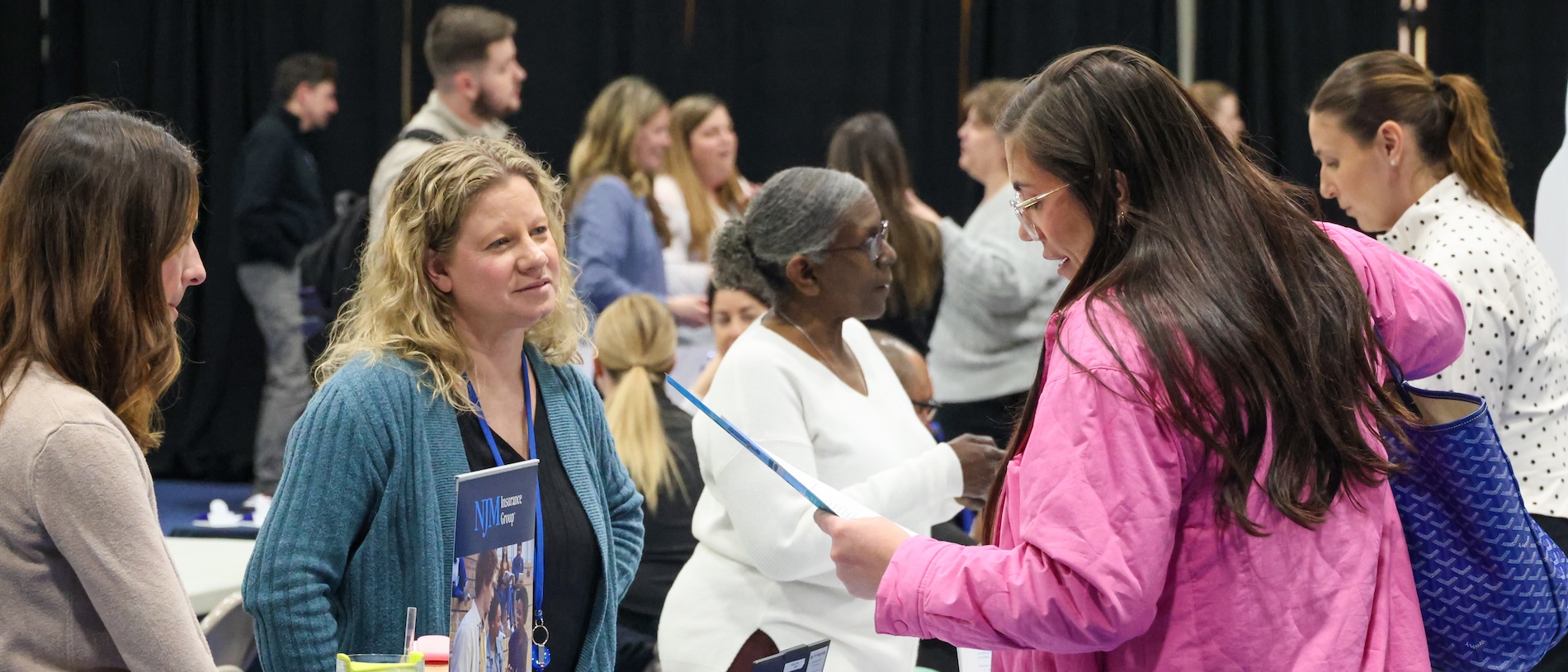 Students at a job fair on campus speaking with employers at tables