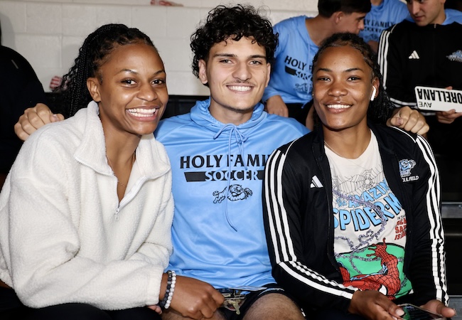 Three students attend an Immersion Day event in the auditorium