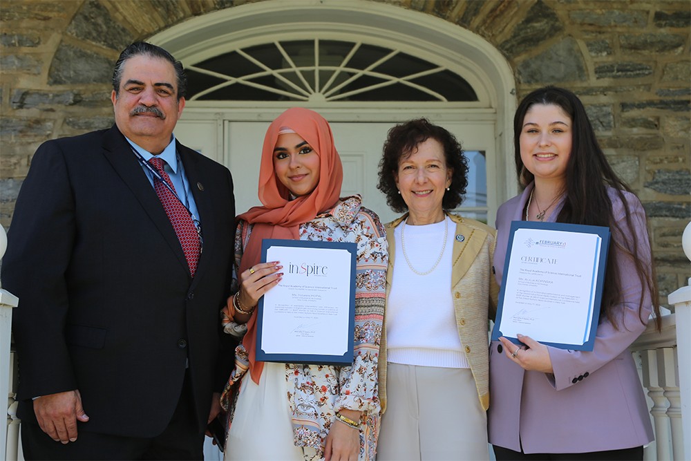 President Anne Prisco, Prince Adnan El-Hashemite and two students