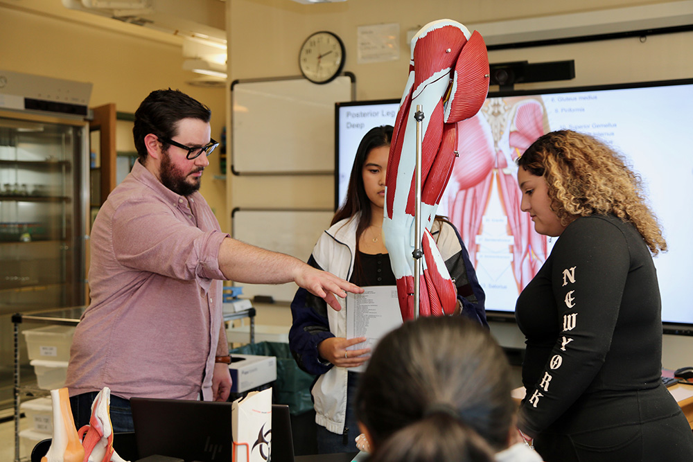 Instructor and students in biology lab
