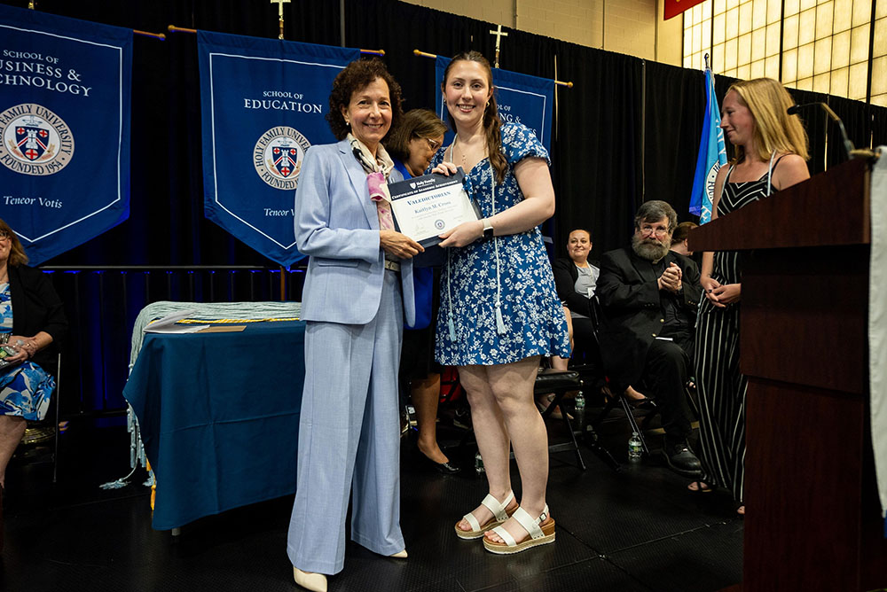 Dr. Prisco and Kaitlyn Cross on stage at ceremony