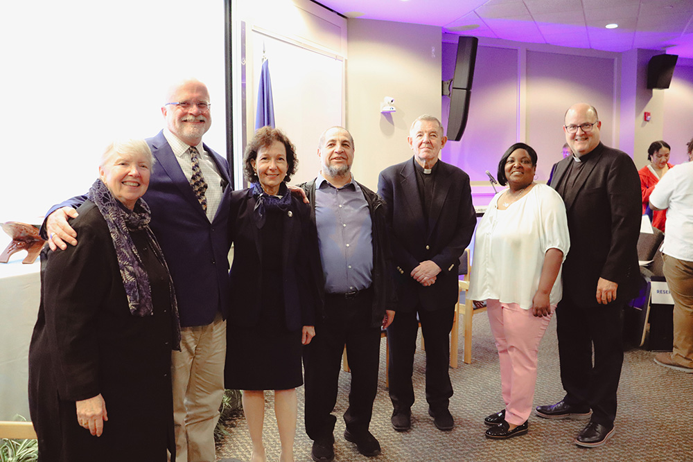 Faith and community leaders with Dr. Prisco