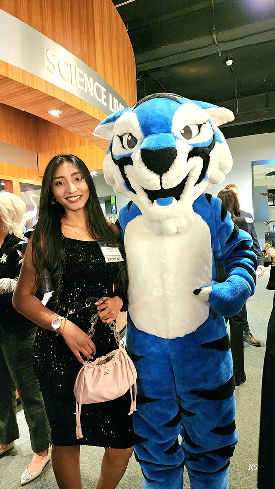 Kawish Sadaqat with Holy Family mascot Blue