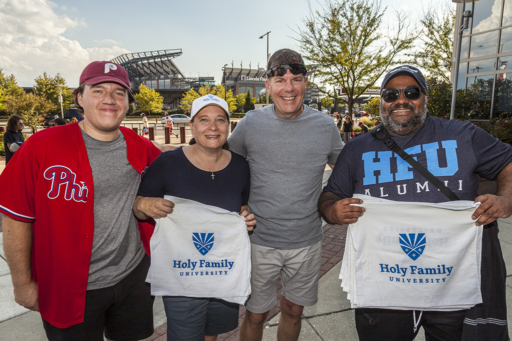 Diane Murphy ’18, Alumni Board Treasurer (second from left), and Roshan Pulimkalayil ’16, M’18, Trustee (far right), were excited to reconnect and cheer on the Phils.