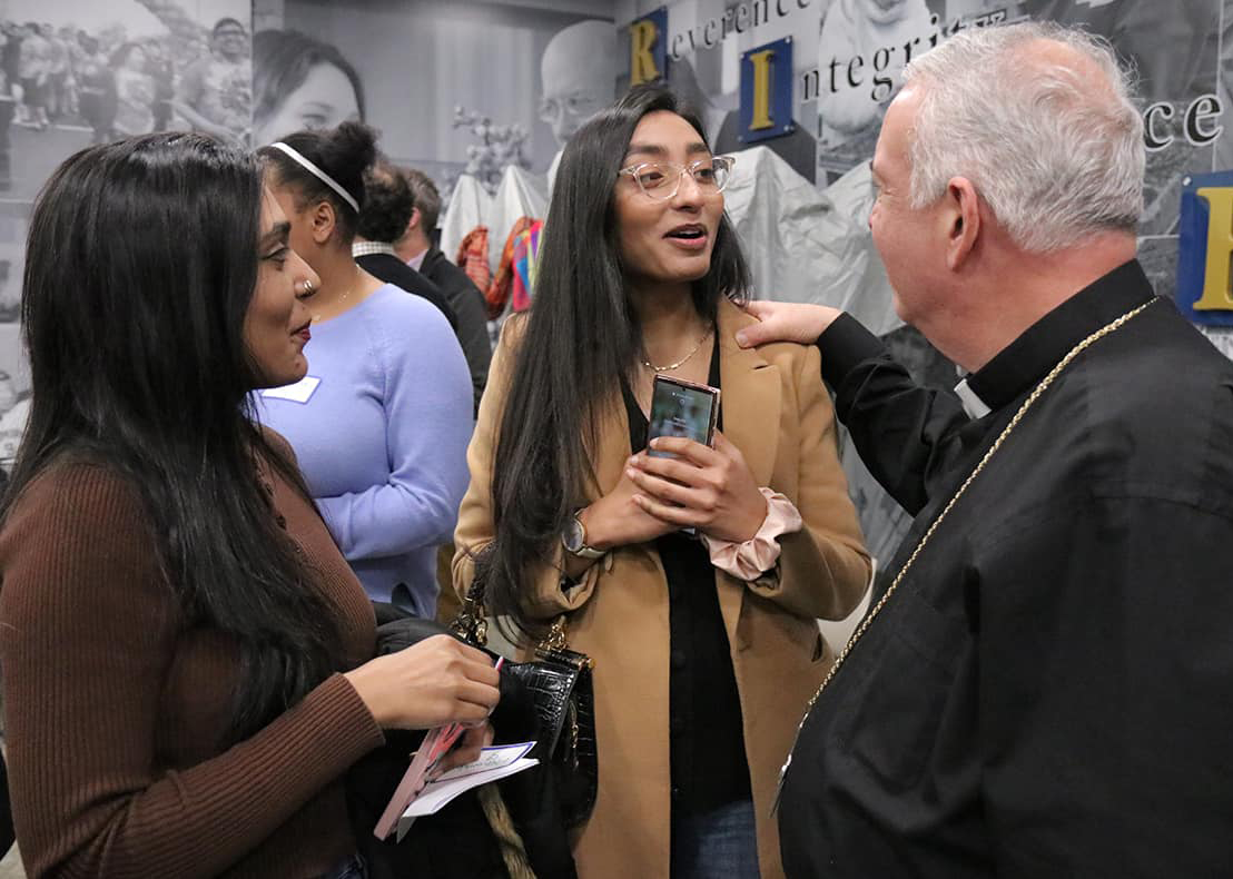 Holy Family students Kawish Sadaqat and Mehwish Sadaqat speak with Archbishop Nelson J. Pérez (Photo credit: Archdiocese of Philadelphia).