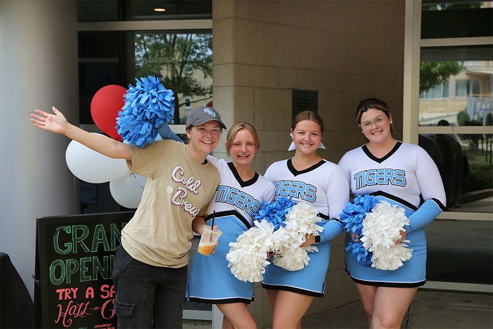 Cheerleaders celebrating opening of Saxbys