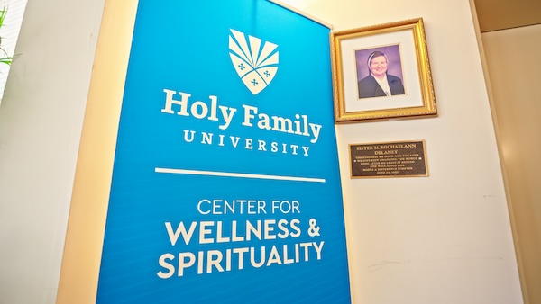 Delaney Hall with the sign for the Center for Wellness & Spirituality