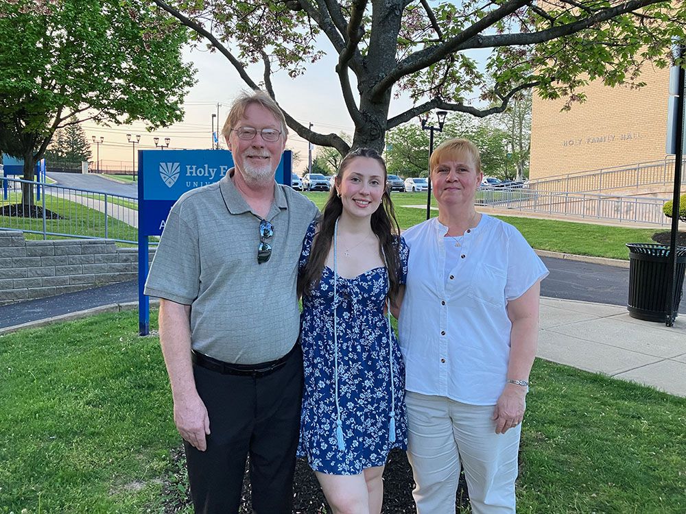 Kaitlyn Cross with her parents on the Holy Family campus