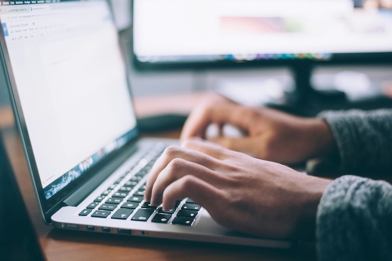 Person typing on their laptop