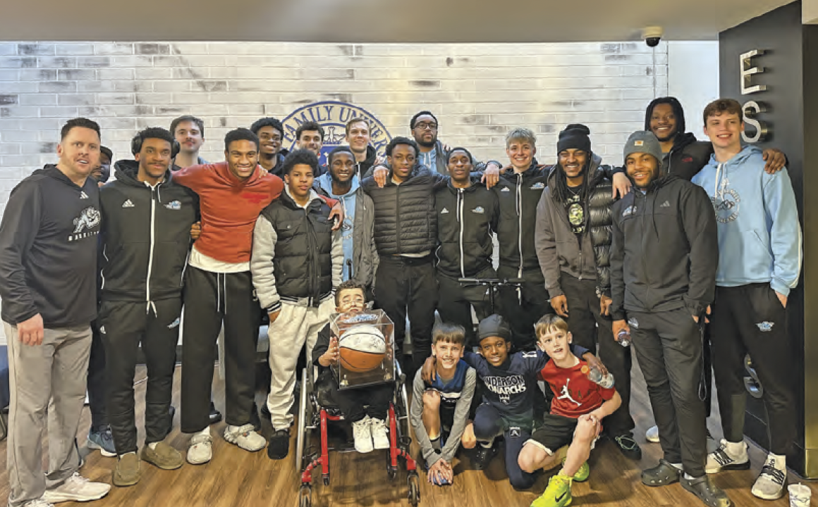 The HFU men’s basketball team with Team IMPACT signing Kevin.