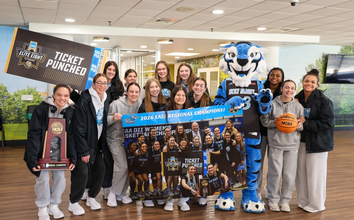 Women's Basketball team celebrating historic victory back on campus