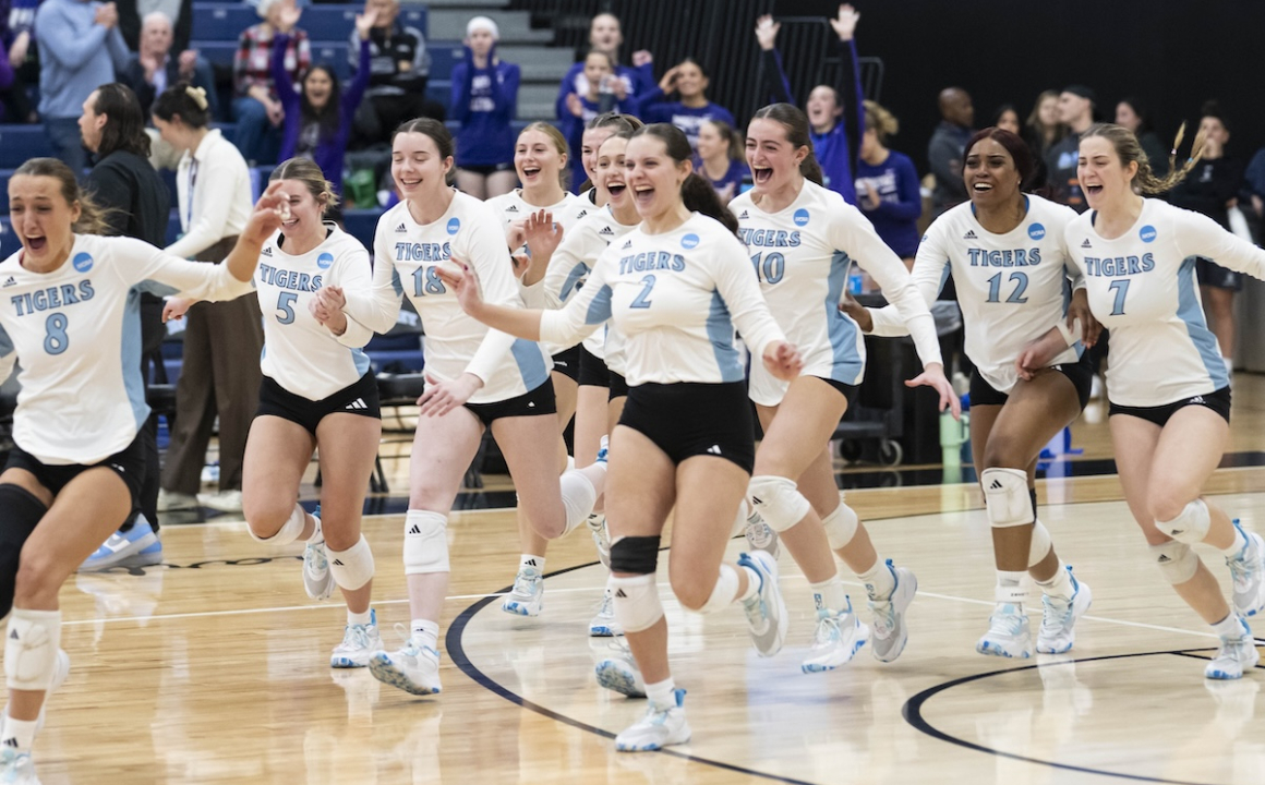 Women's Volleyball team running onto the court after a win