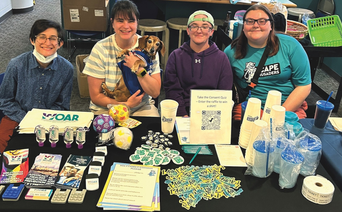 Quinn Sunnolia from WOAR; Kate Coffey with Jackson (a dog, the four-legged CAPE mascot); Cameron Bristow, vice chairperson for the CAPE Crusaders; and Amanda Knipe, chairperson for the CAPE Crusaders