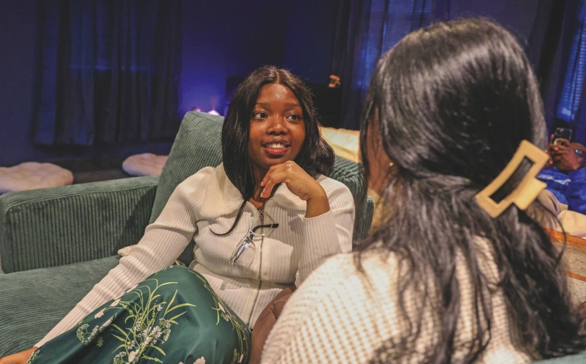 Two Holy Family University students sharing a quiet conversation in the Zen Den.