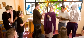 Father MacNew giving Communion