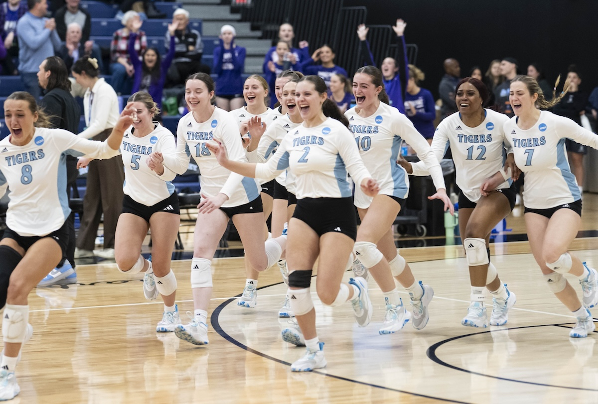Women's Volleyball team running onto the court after a win