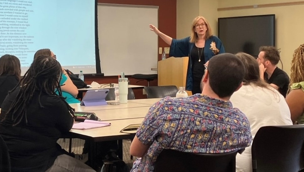 Award-winning poet Erin Belieu speaks with students in classroom as part of Holy Family University's low-residency Master of Fine Arts in Creative Writing program.