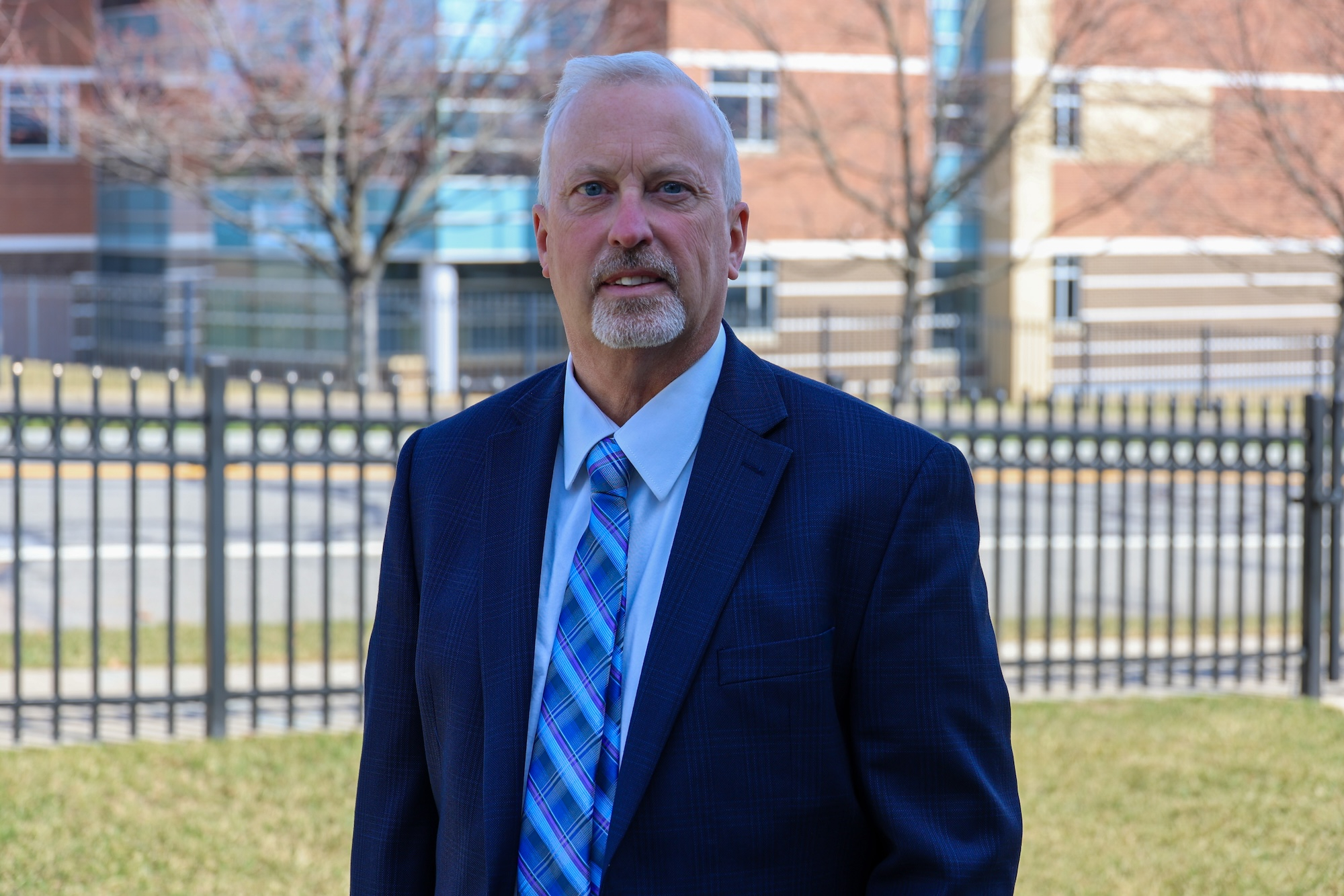 Tobin Porterfield, Ph.D. standing outside on the Holy Family campus