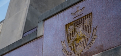 Holy Family University shield with teneor votis motto on Holy Family Hall