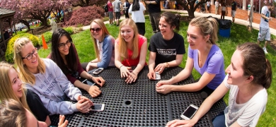 Girls sitting outside at a round table