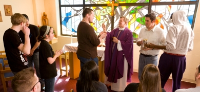 Father MacNew giving Communion