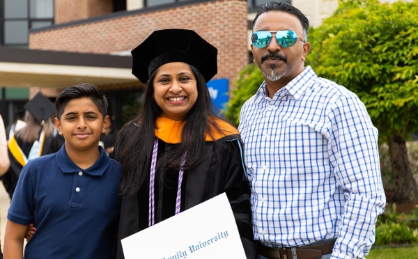 Dr. Jinsy Mathew and her family at her DNP graduation